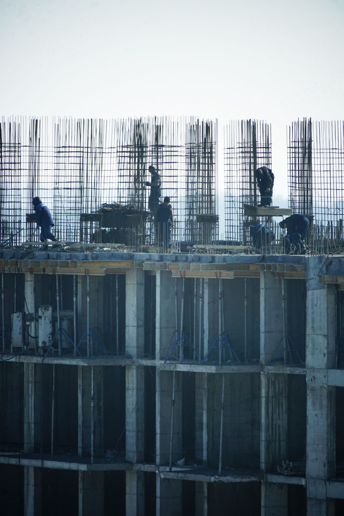 Multi-storey building under construction with rebar columns