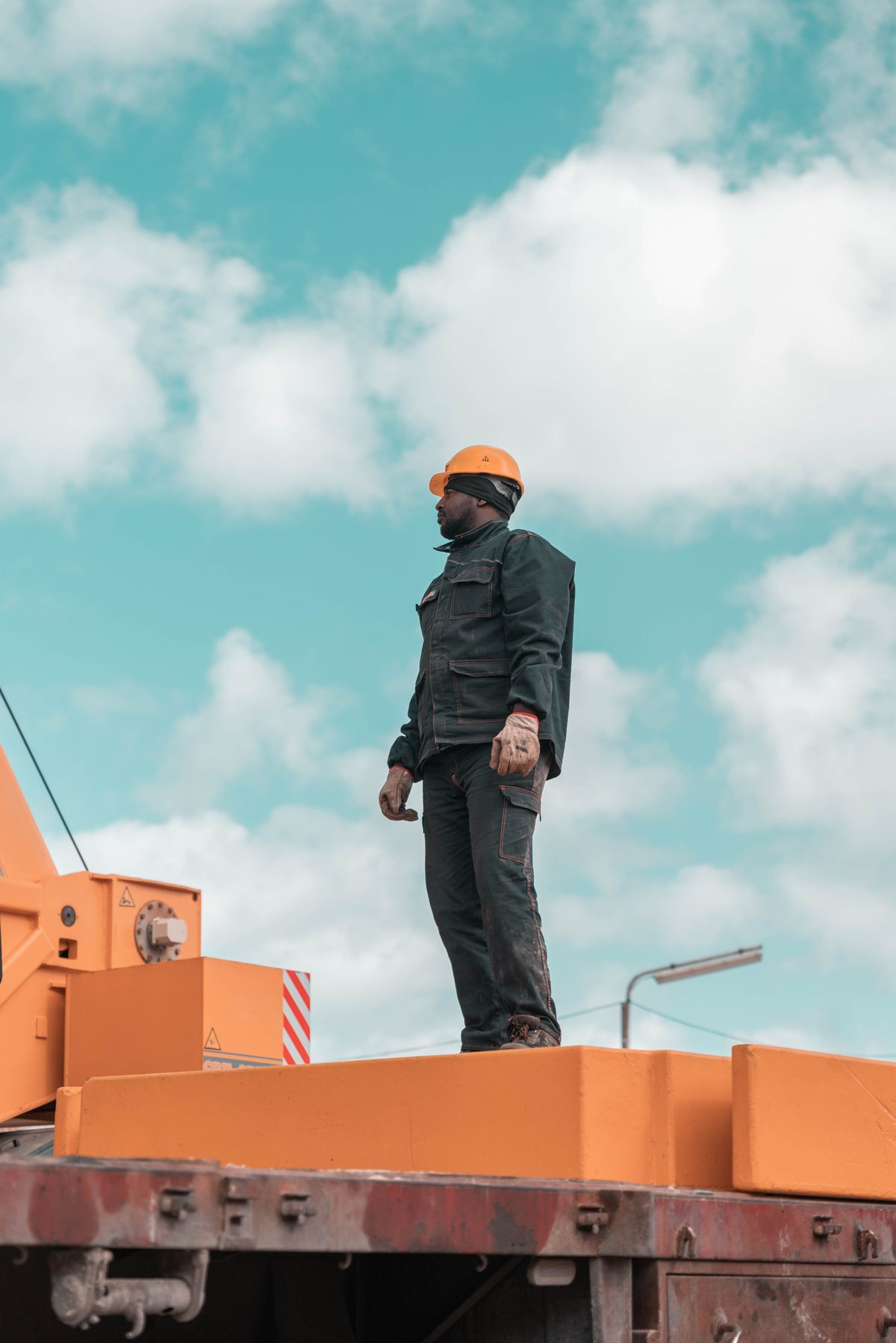 Site supervisor in a hard hat overseeing a construction site