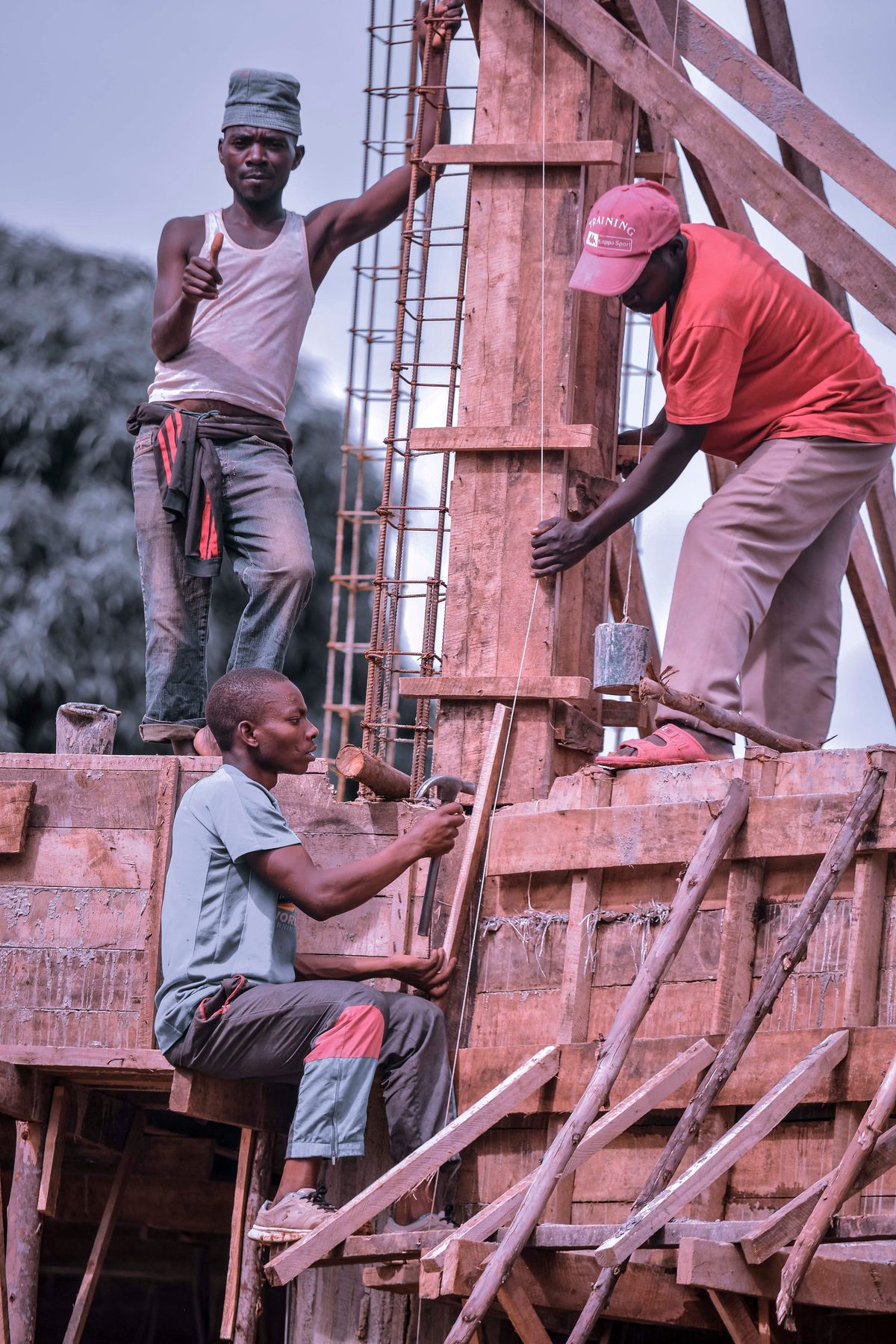 Workers building wooden formwork for a concrete structure